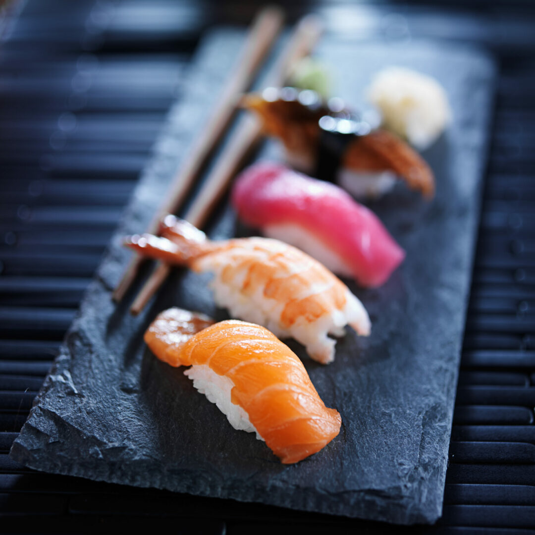 Assorted sushi nigiri on slate